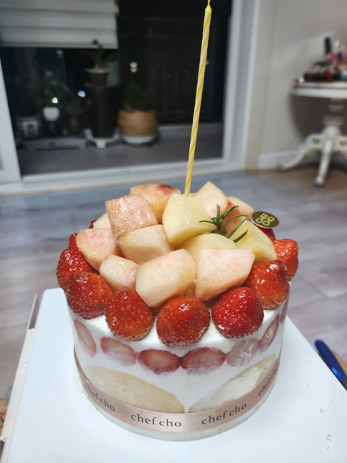 Peach berry cake topped with peaches and strawberries