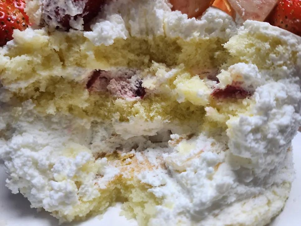 A slice of peach berry cake on a plate