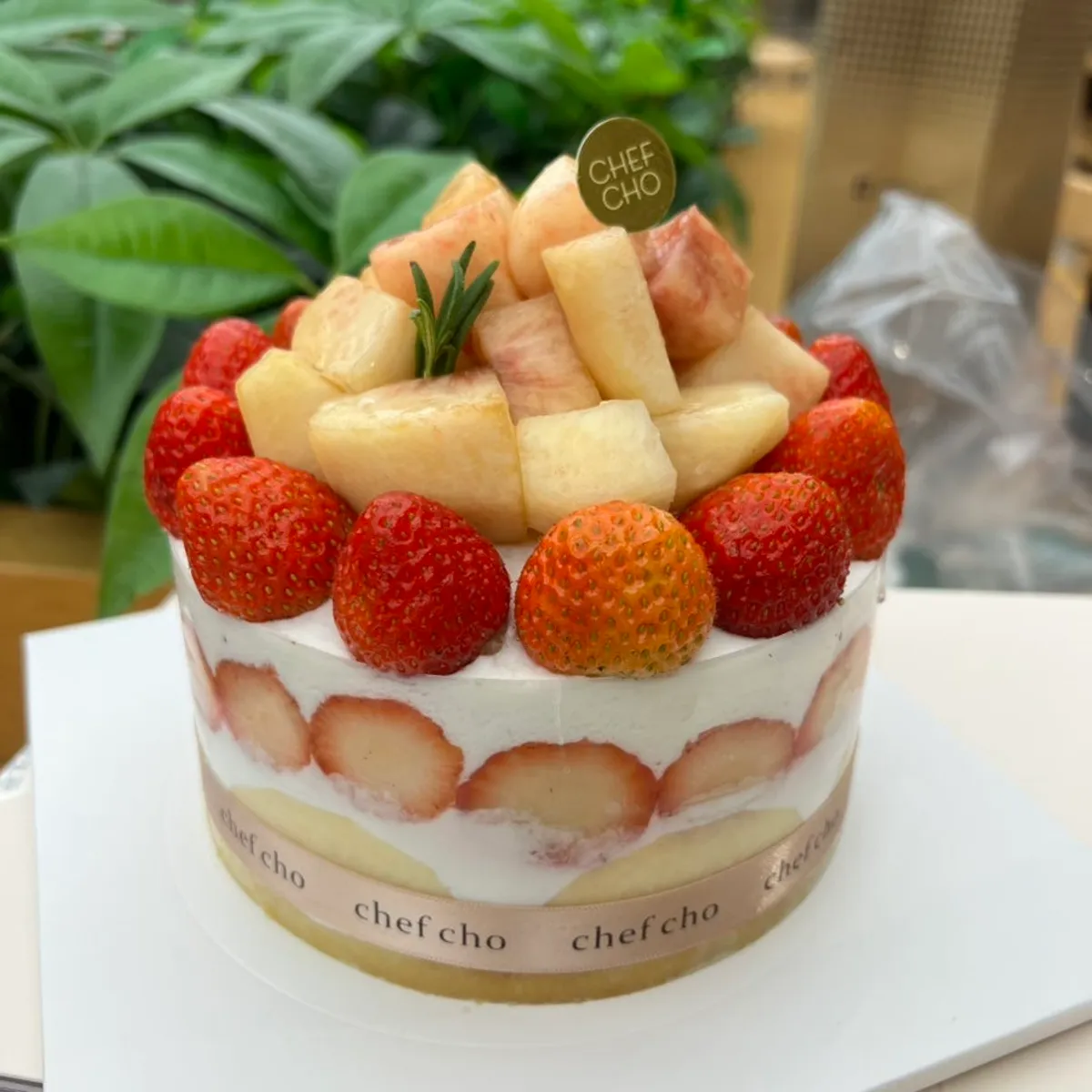 Chef Cho's Peach Berry cake topped with peach and strawberry