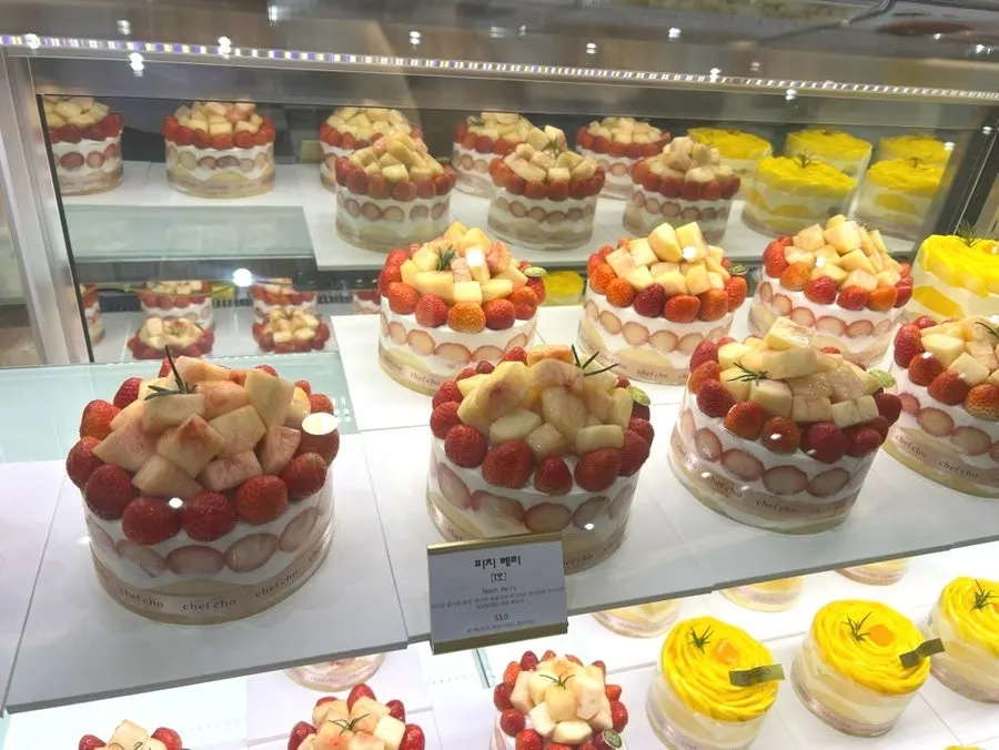 Rose-shaped Real Mango Rose and Peach Berry cakes on display