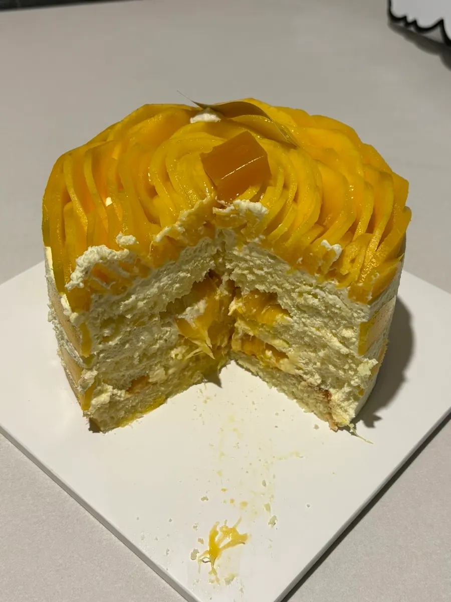 A cut slice of the Real Mango Rose cake