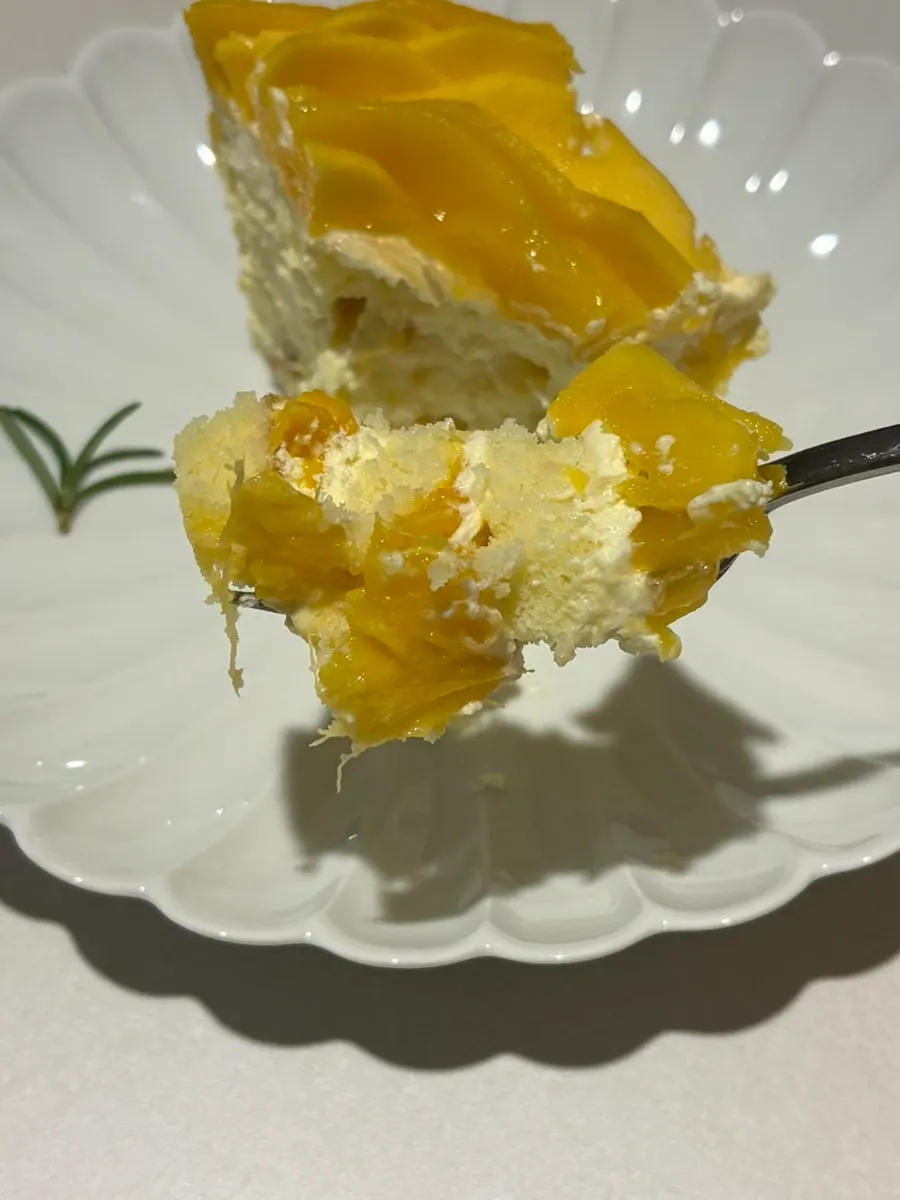 A slice showing the mango cream and sponge layers