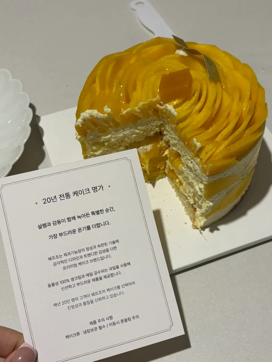 Eating a plated slice of Chef Cho's mango cream cake
