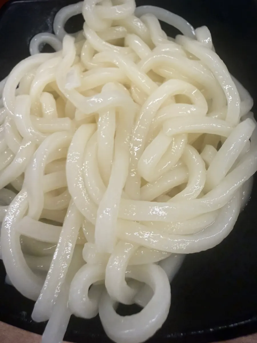 Dipping seasoning into the broth