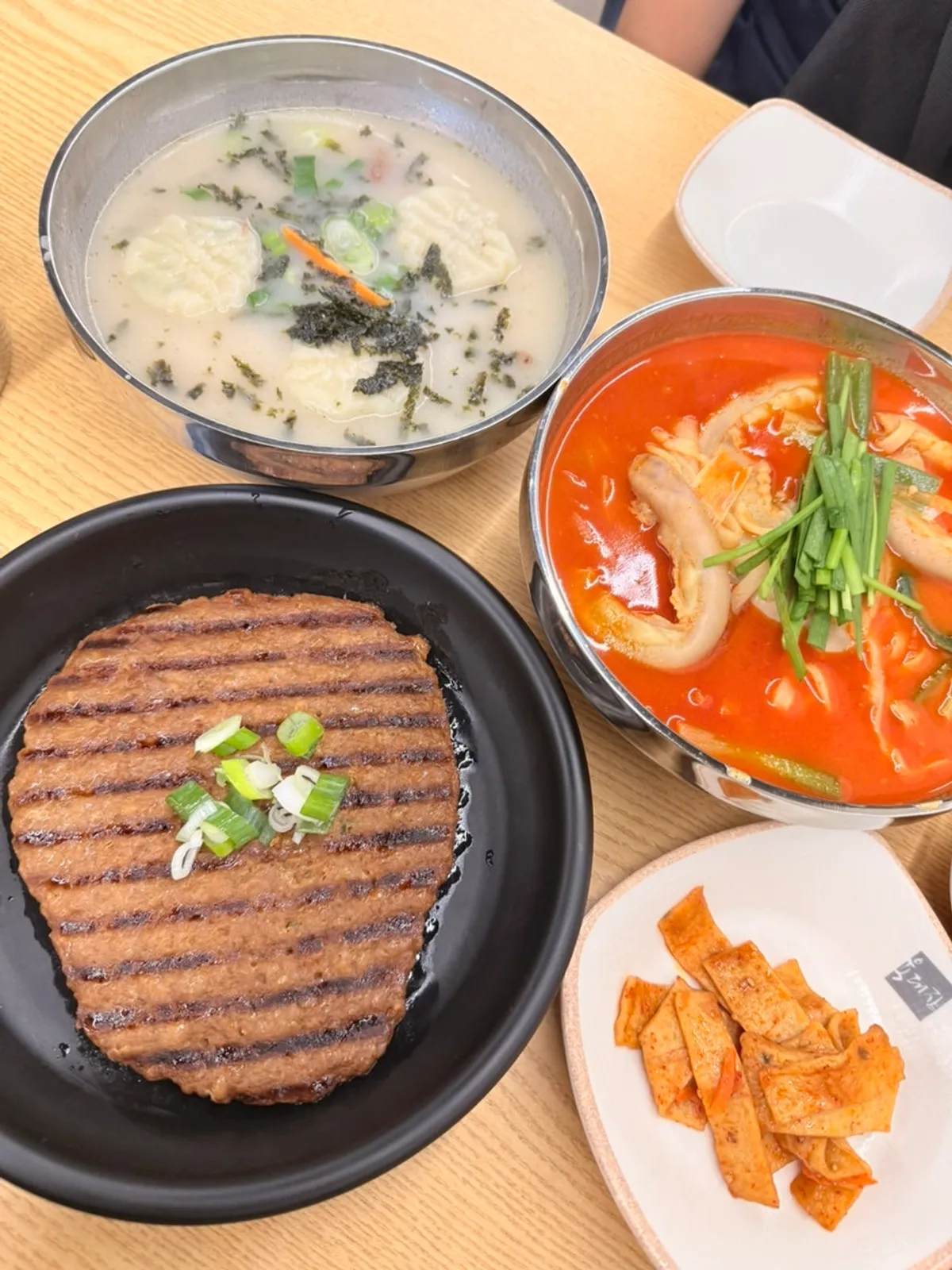 Full spread of Gopchang Wangchang Saengyuk Kalmyeon and tteokgalbi