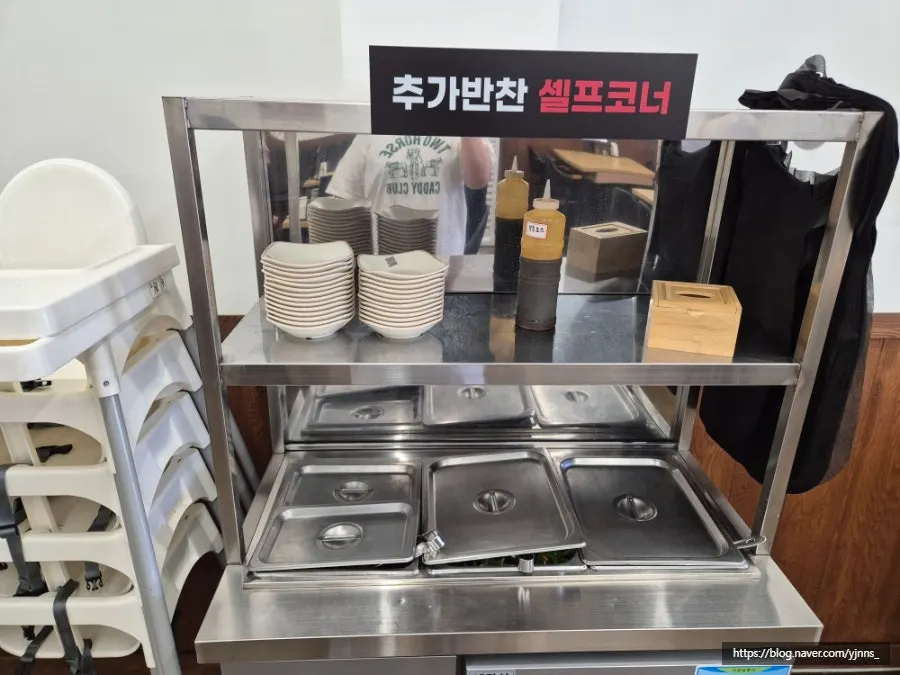 Yukdaejang's self-serve side dish bar with individual lids