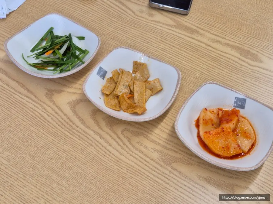 Basic side dishes of chives, fish cake, and seokbakji