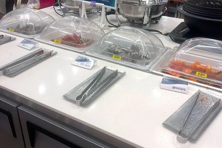 Self bar side dish corner with lids covering the dishes