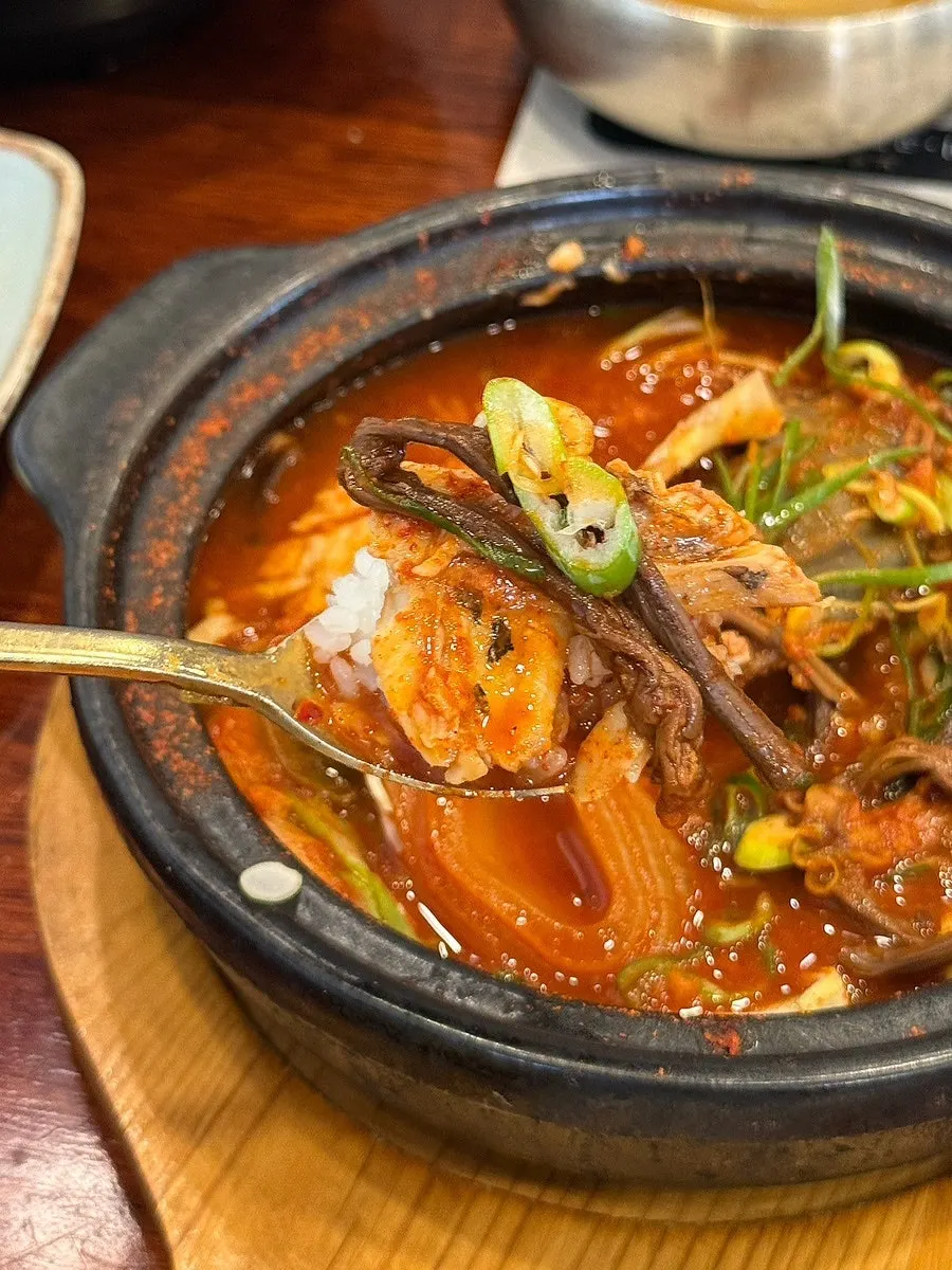 A piece of pomfret dipped into the braising broth
