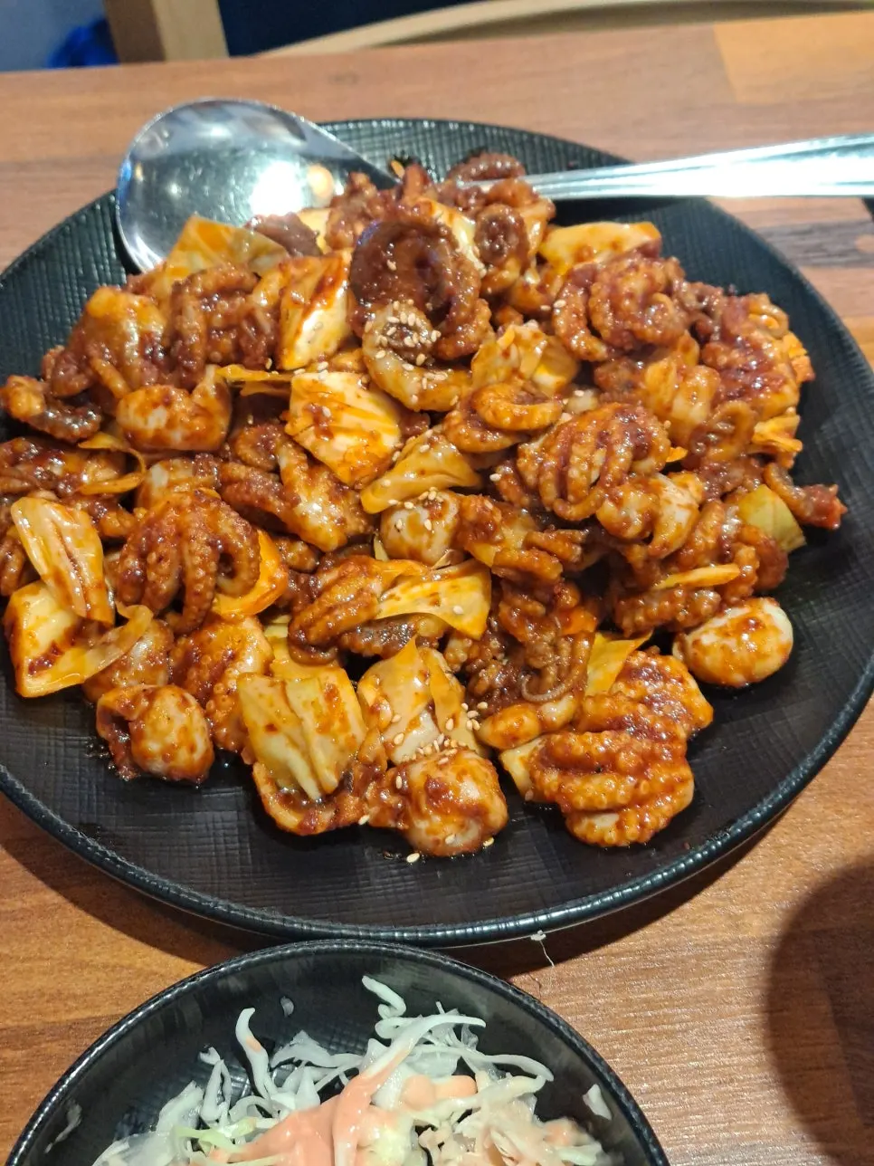 Fried shrimp being dipped into mayo sauce