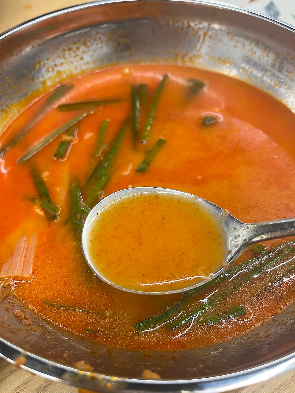 A spoonful of rich yukgaejang broth