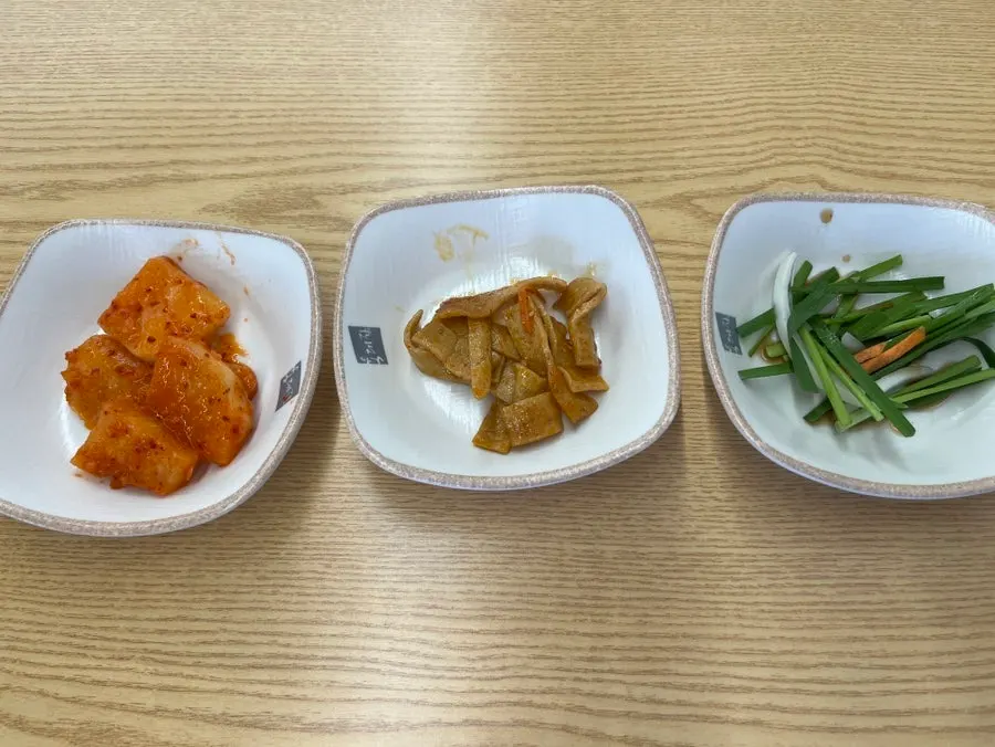 Three side dishes: kkakdugi, stir-fried eomuk, and jeonggu-ji