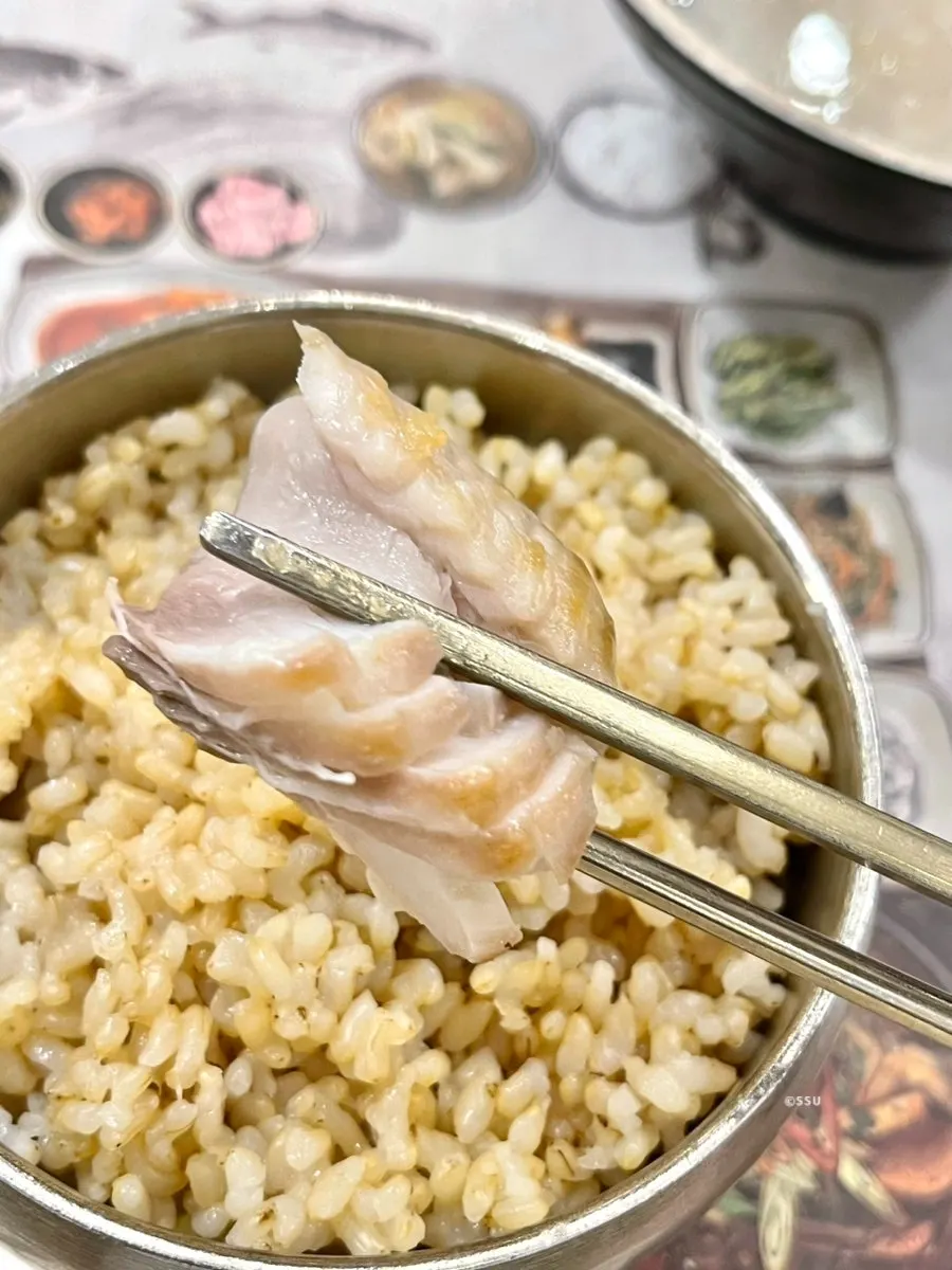 삼치구이 한 점을 간장에 찍는 모습