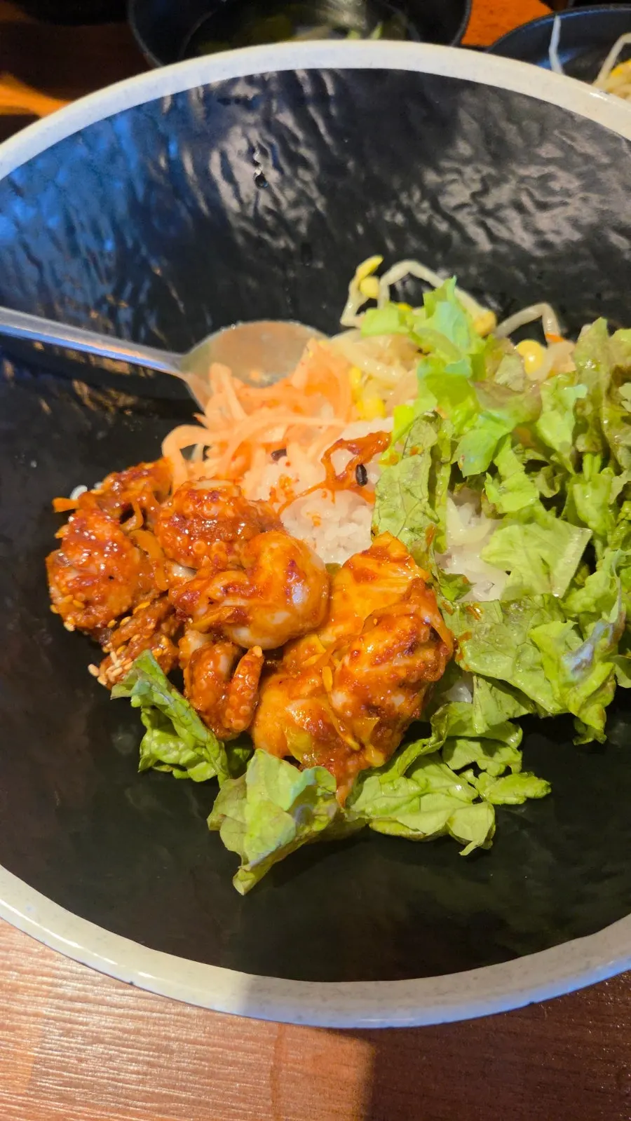 A plate of jjukkumi coated in spicy seasoning