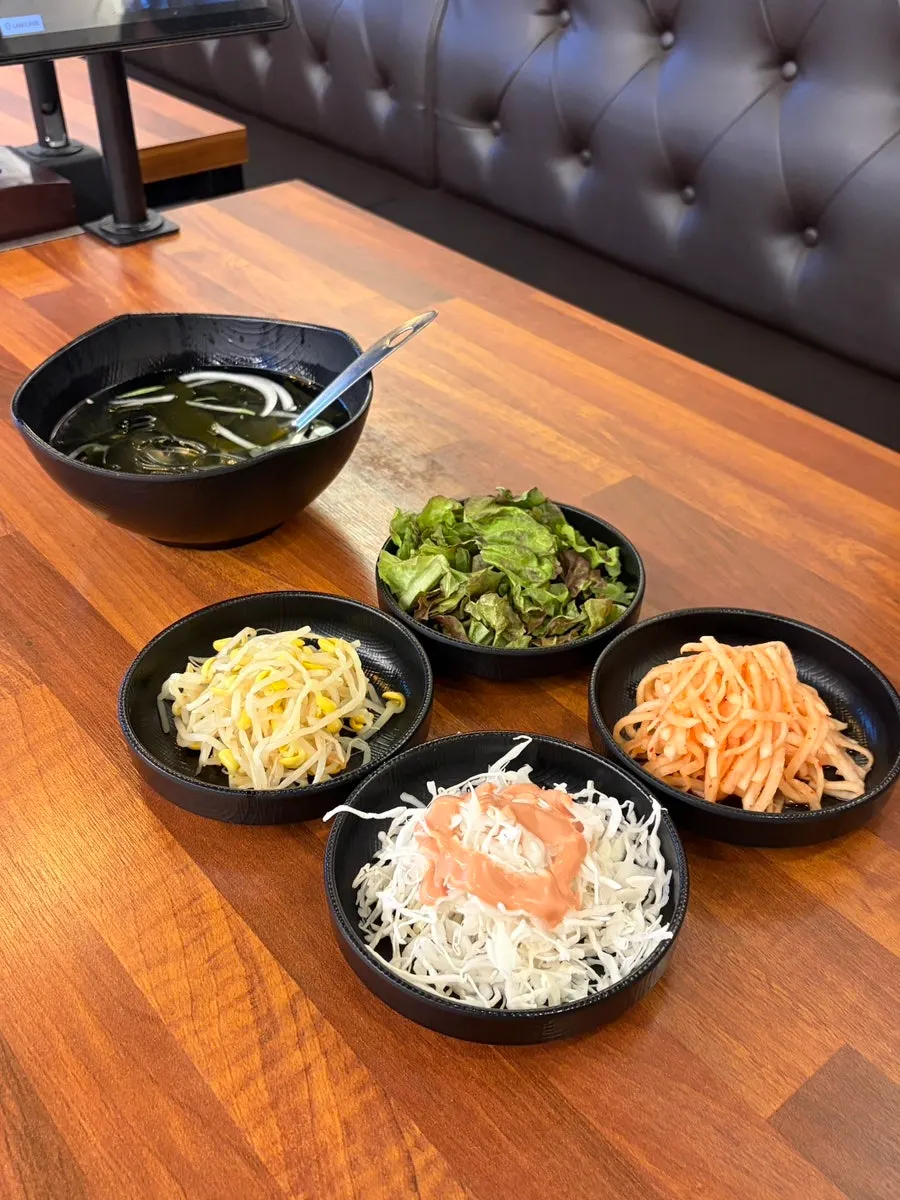 Basic banchan spread including cold cucumber soup and radish salad