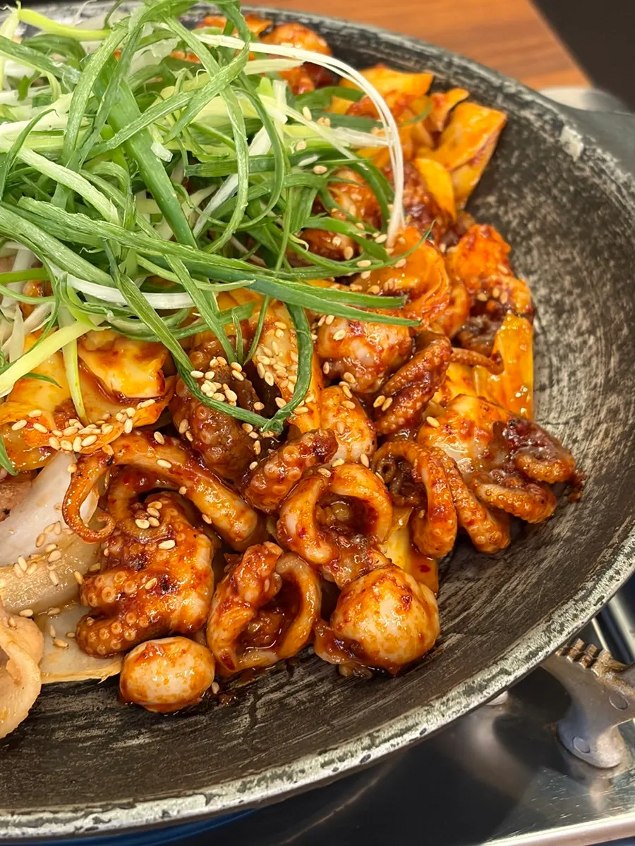 Jjukkumi samgyeopsal kept warm over a burner