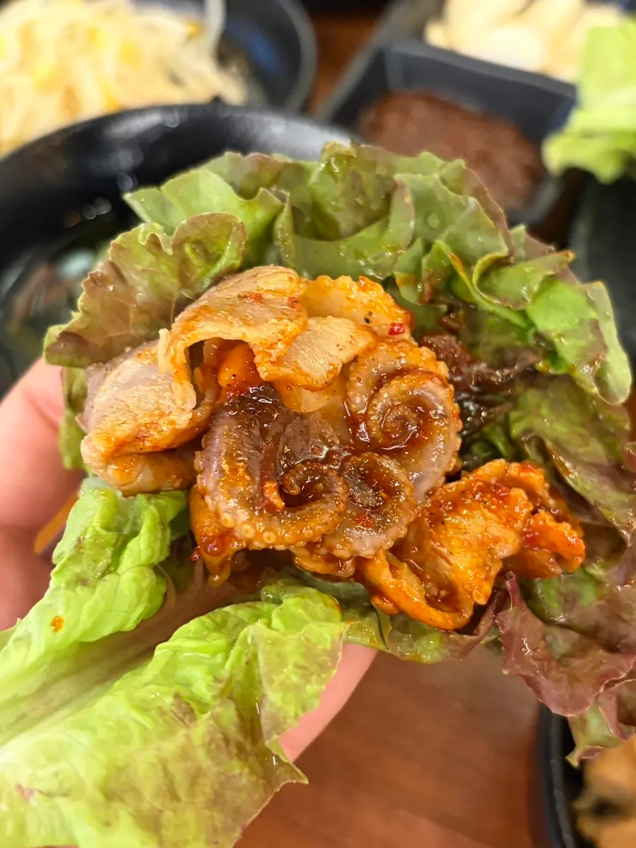 Jjukkumi samgyeopsal wrapped in lettuce