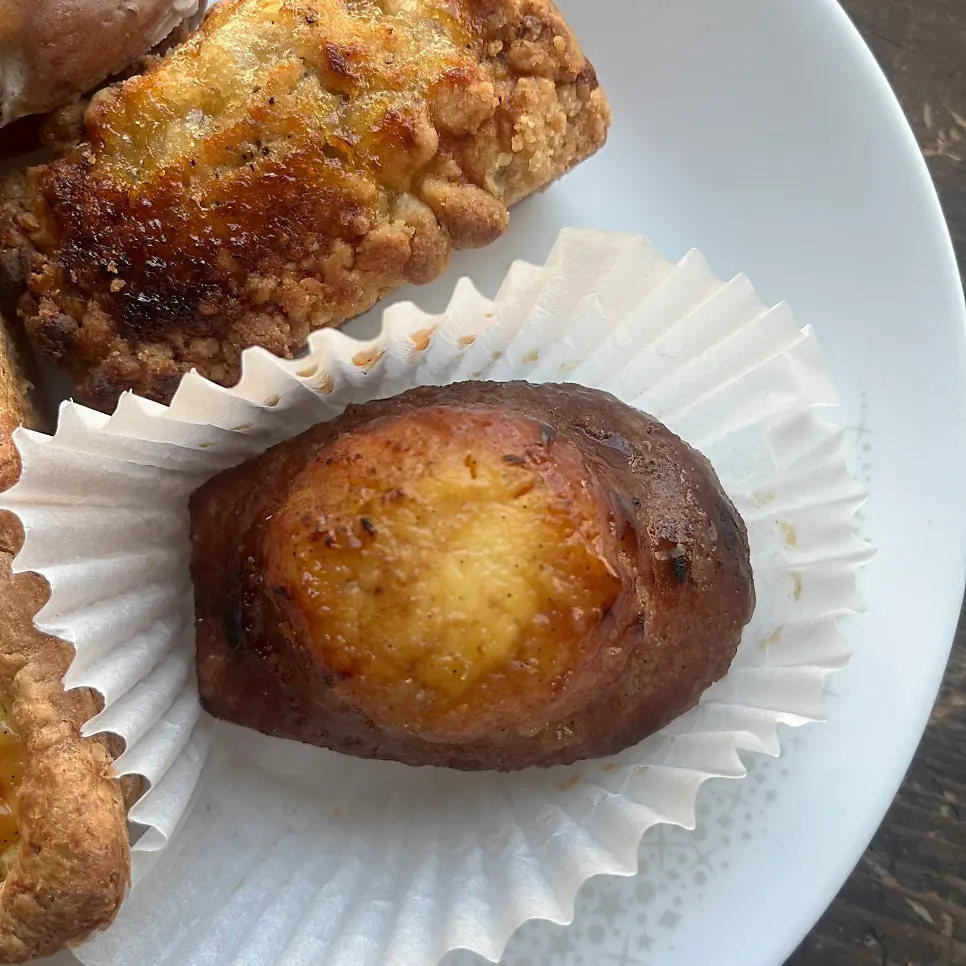 Bitten cross-section of crème brûlée madeleine