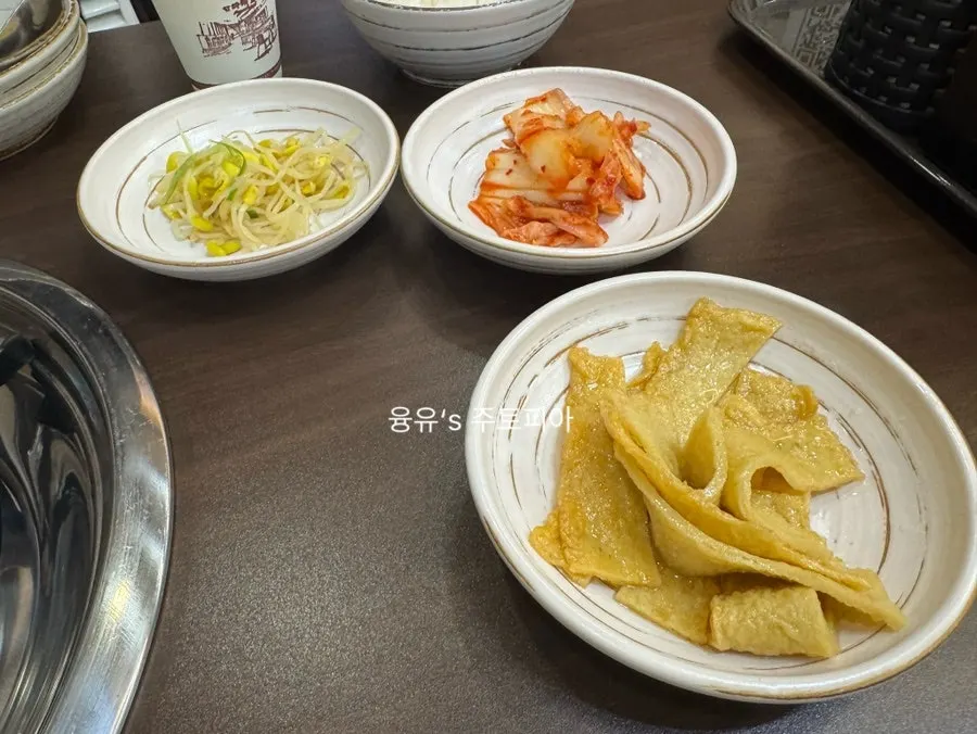 Budae-jjigae with neatly prepared side dishes