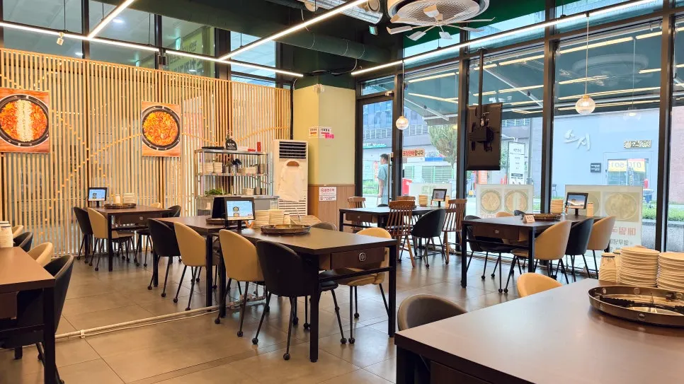 Spacious interior with large windows and wood-toned partitions