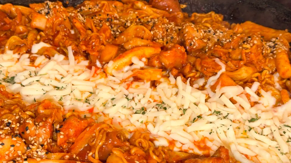 Cheese dakgalbi with cheese piled in the center of the cast-iron pan