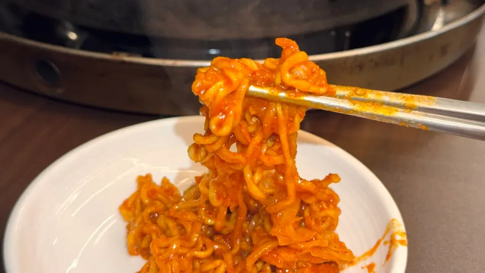 Close-up of dakgalbi draped in melted cheese