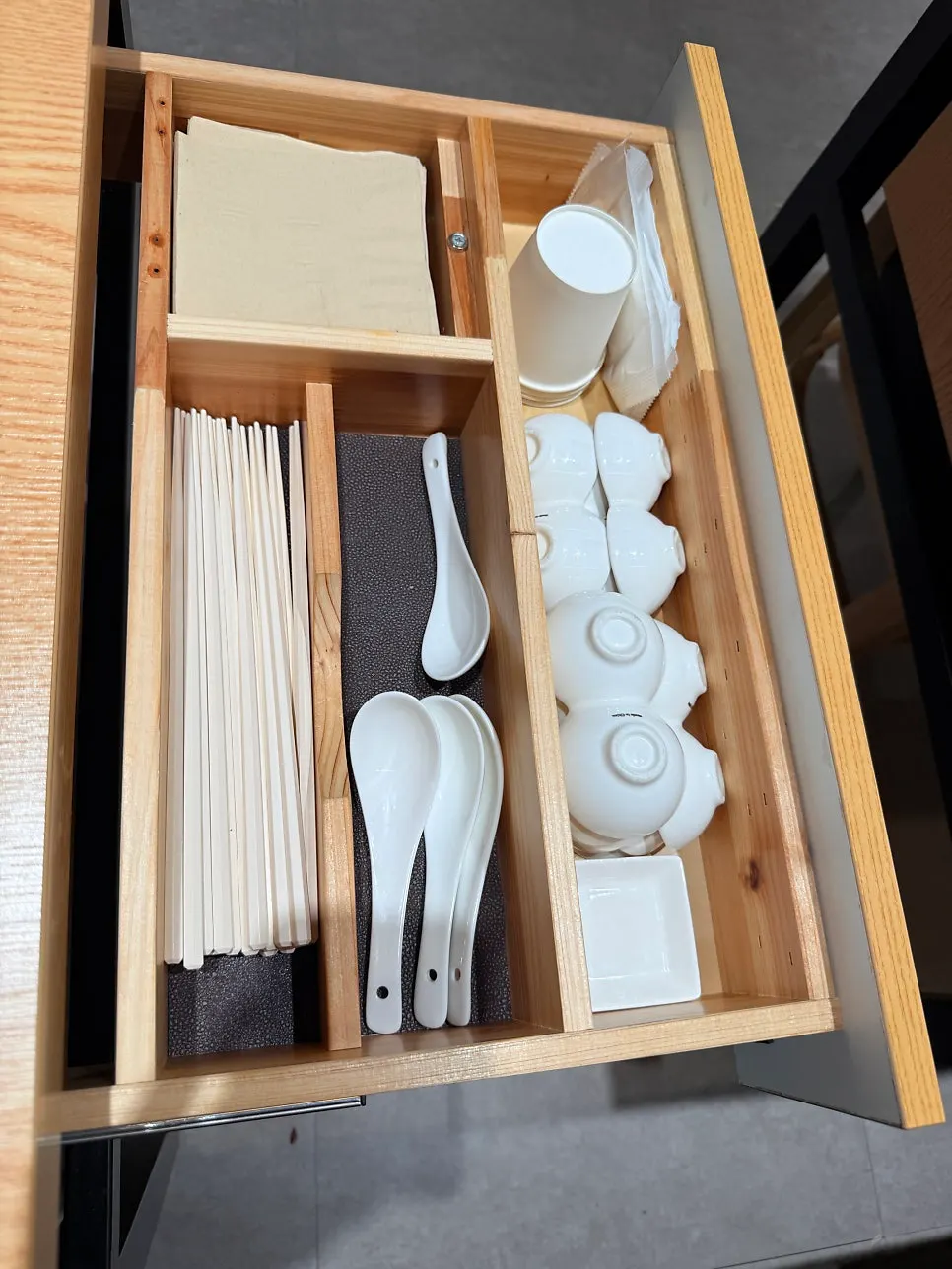White chopsticks and soy sauce dish set on the table