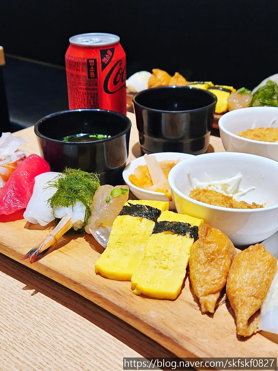 Table spread with two orders of Ganghan Sushi 12P