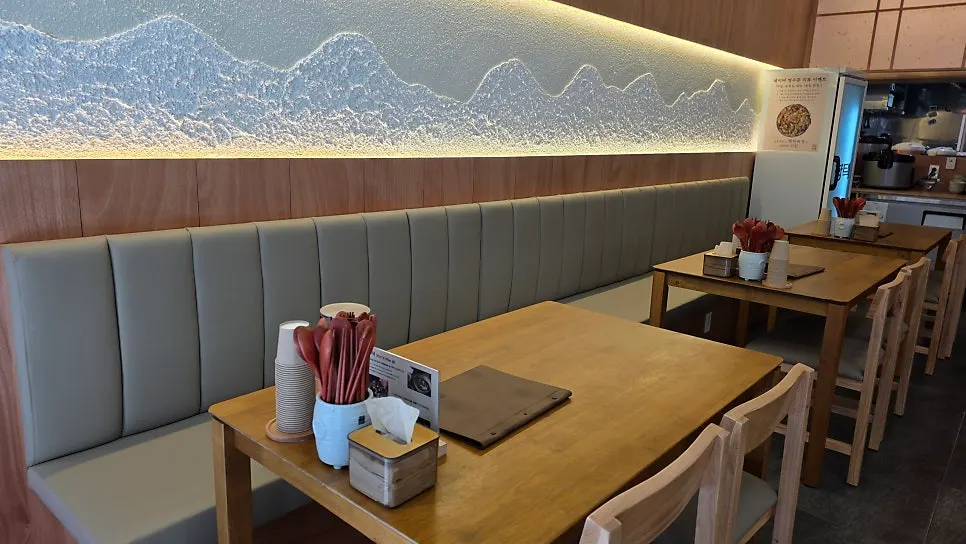 Interior with wood-toned tables and wall-facing seating
