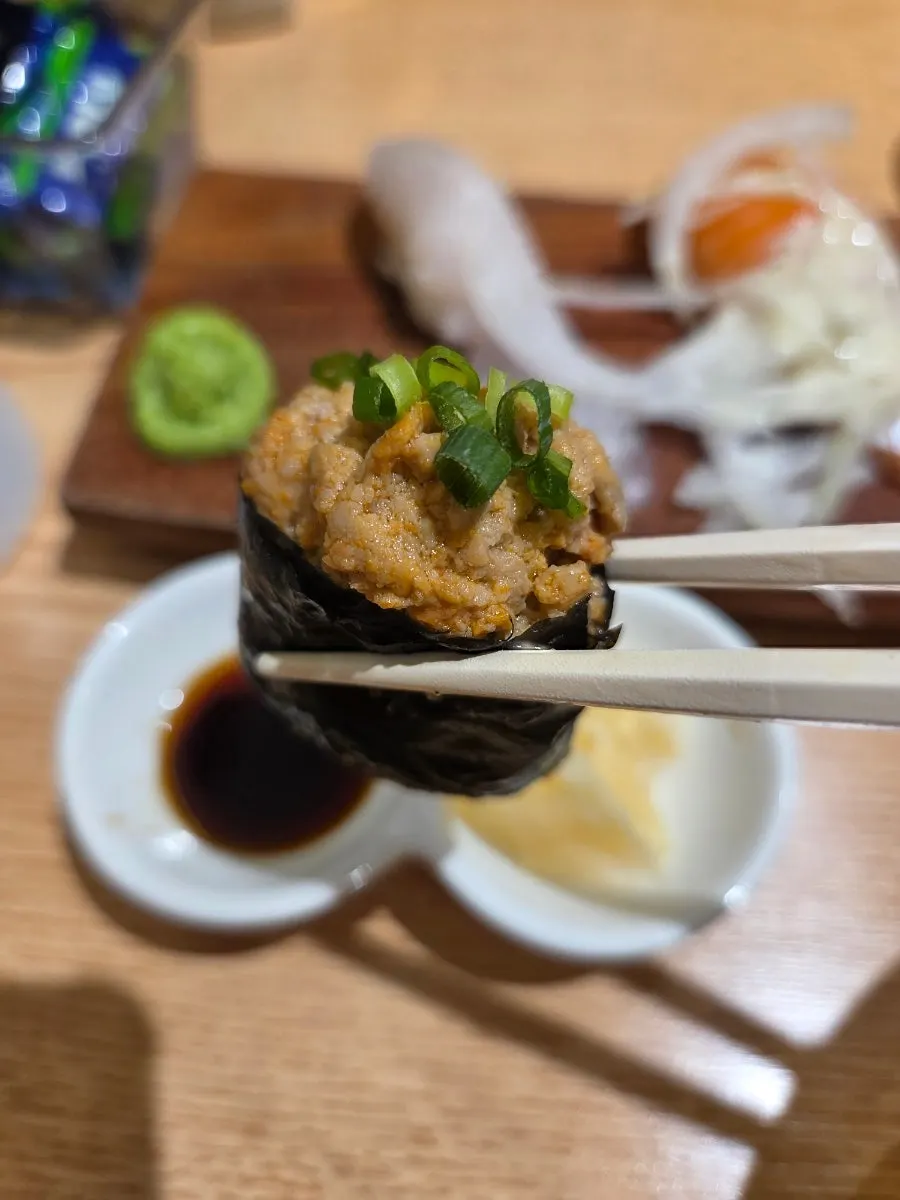 A piece of gunkan-style sushi