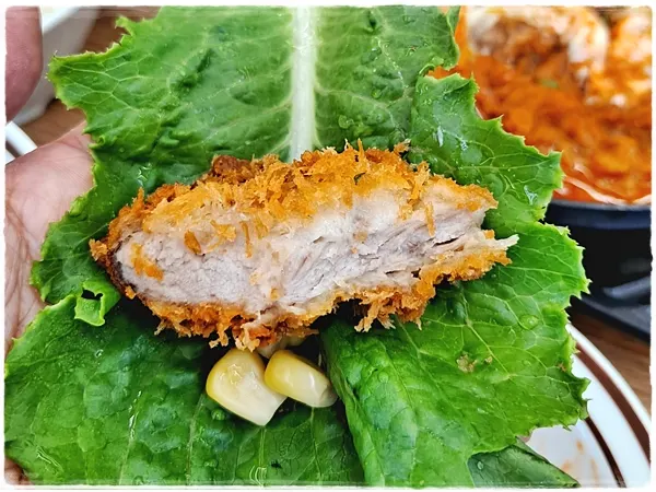 Pork cutlet eaten as a lettuce wrap