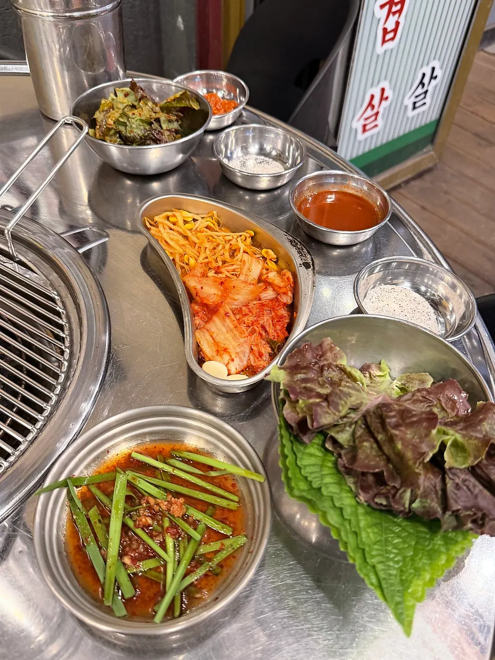 Table set with chive salad, kimchi and other basic side dishes