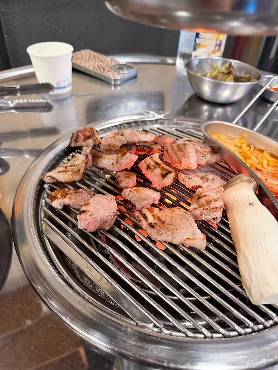 Pork belly sizzling over charcoal