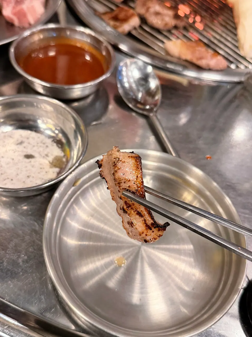Pork neck and skirt meat grilling over charcoal