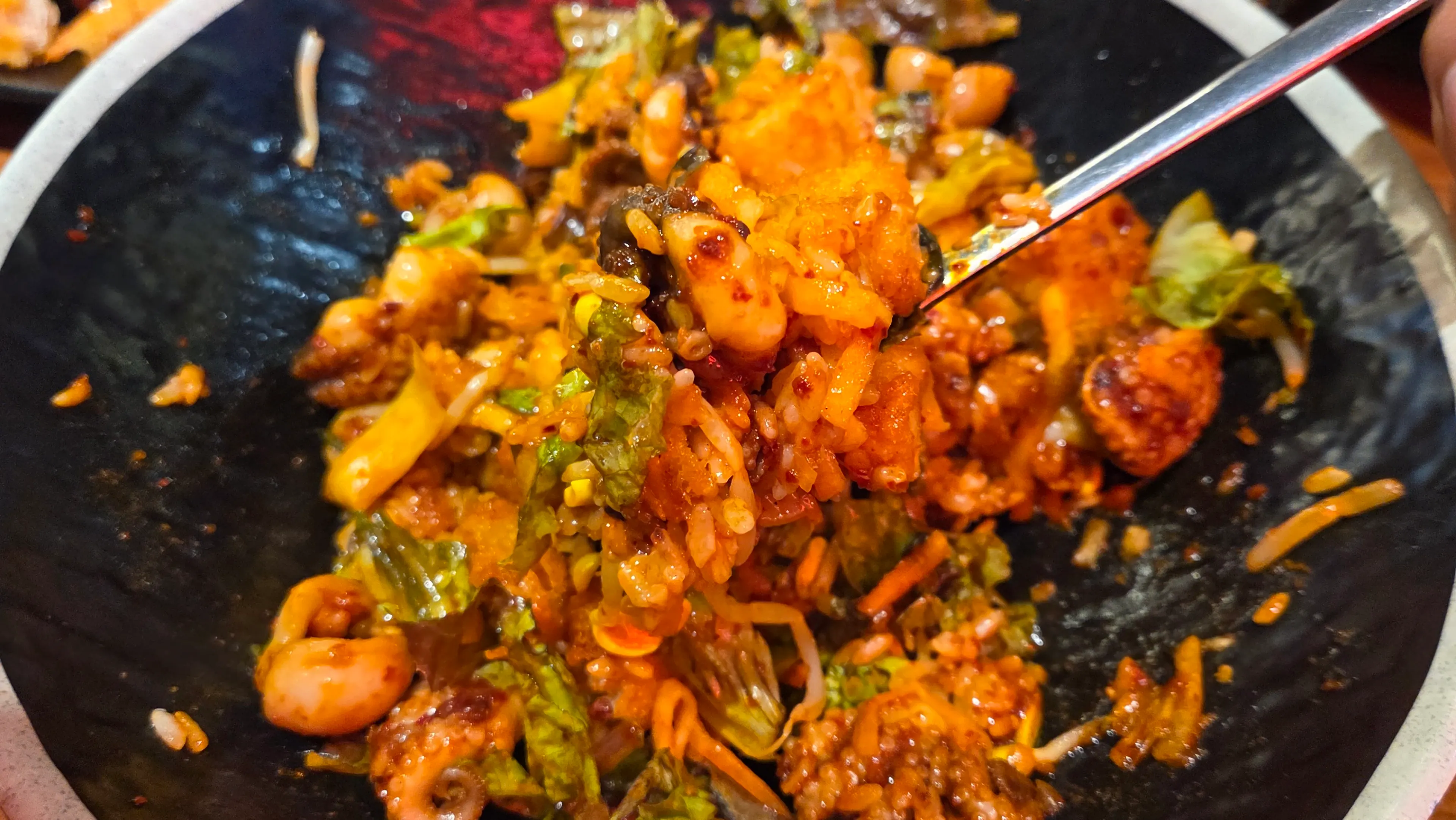 Jjukkumi bibimbap mixed evenly with sauce