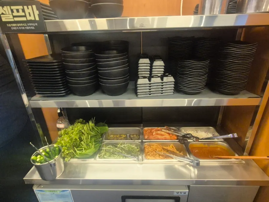 Self-service side-dish bar with whole-head kimchi