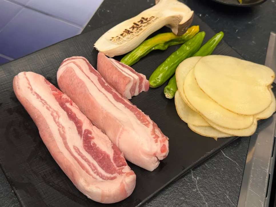 Jirisan black pork belly served with potato slices