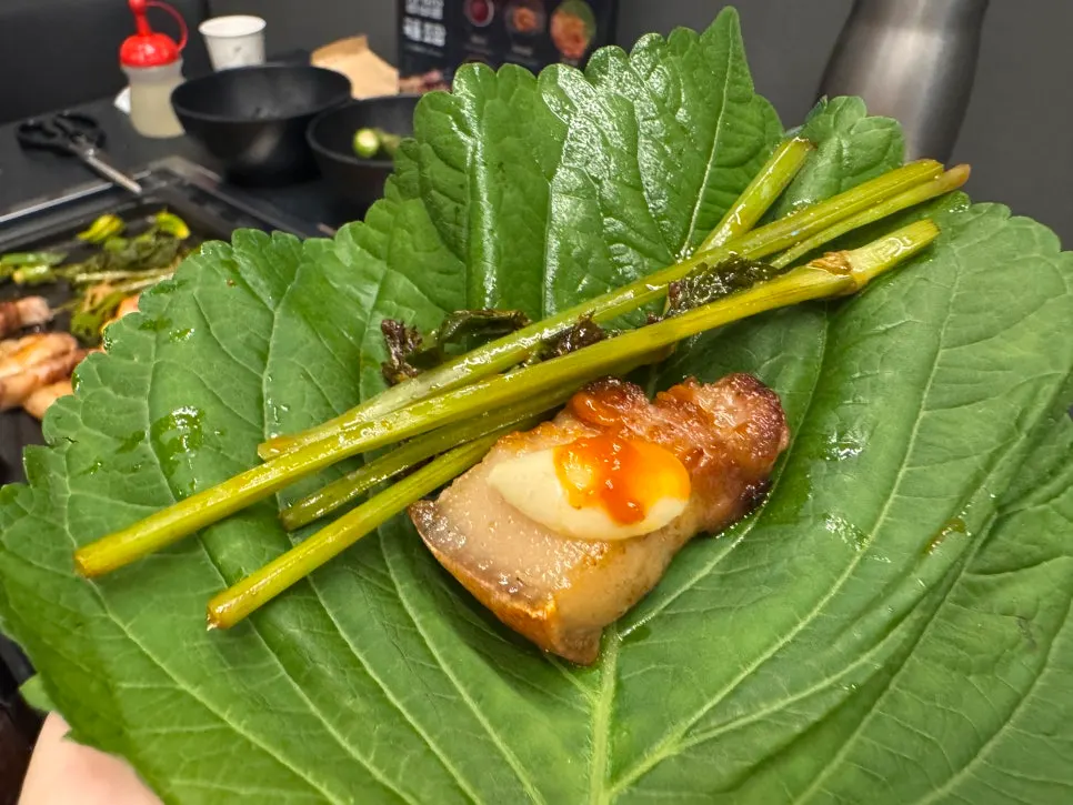 Black pork belly wrapped in a perilla leaf