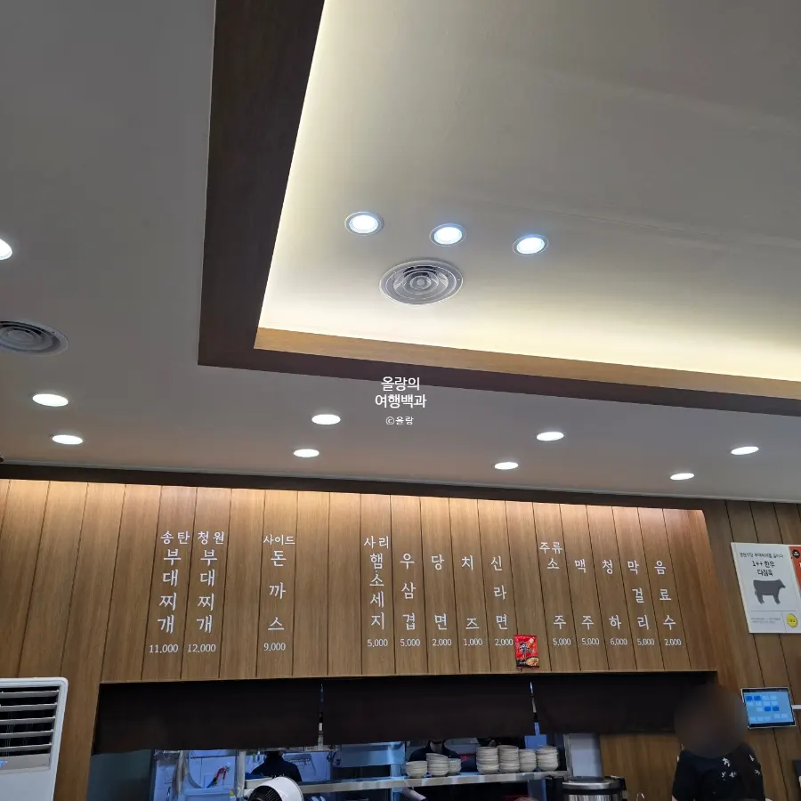 Menu board listing Songtan and Cheongwon budae-jjigae