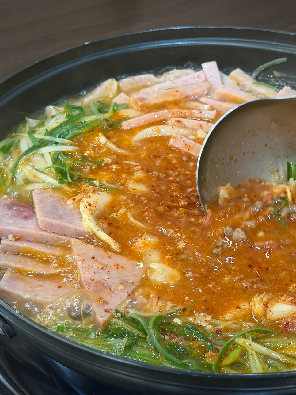 Songtan budae-jjigae simmering with the broth turning richer