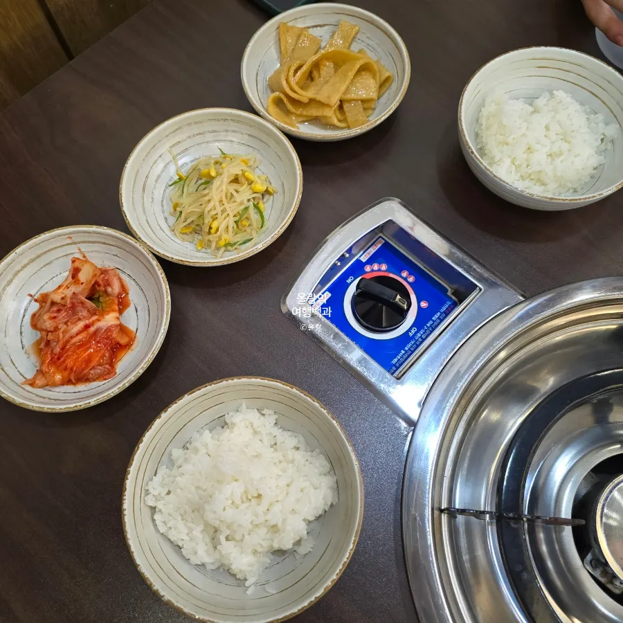 Side dishes of stir-fried fish cake, seasoned bean sprouts and kimchi