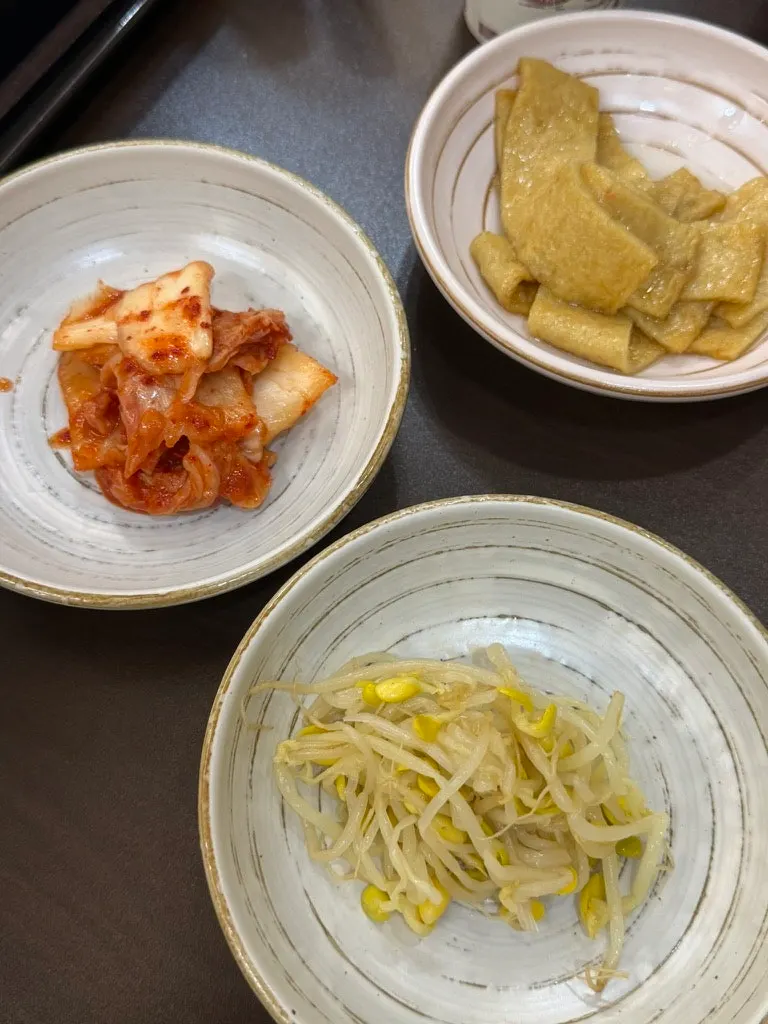 Basic side dishes: kimchi, bean sprouts, and fish cake
