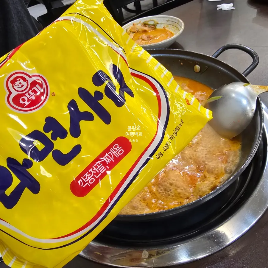 A pot of budae-jjigae with ramyeon noodles added
