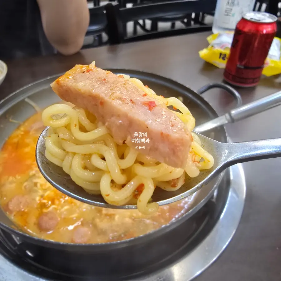 An emptied pot of budae-jjigae and rice bowl