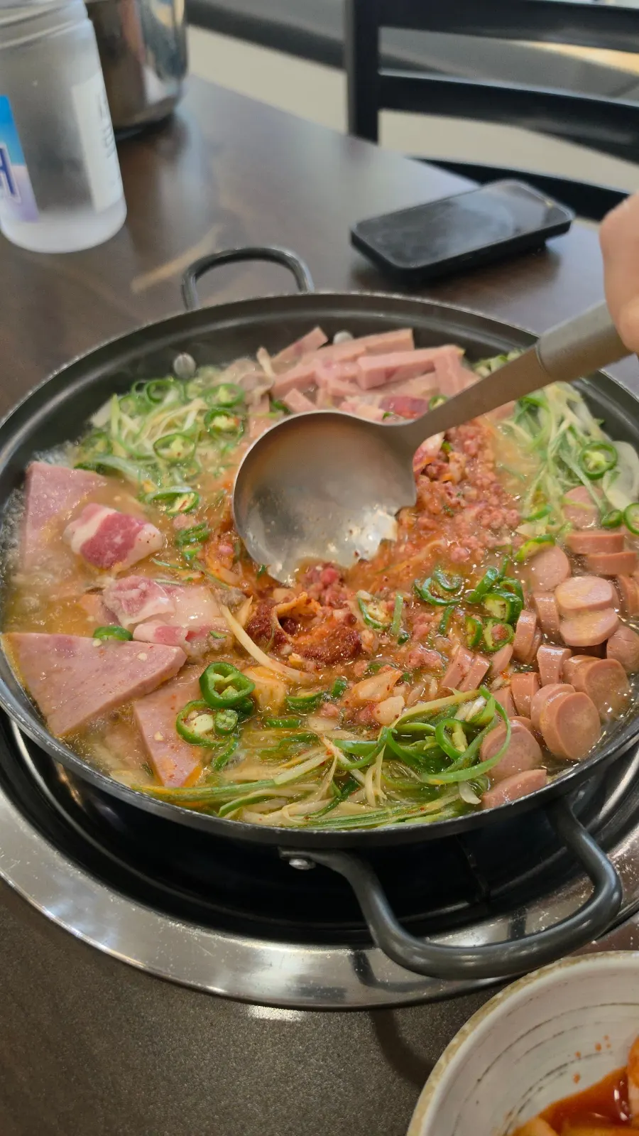 Cheongwon budae-jjigae simmering with the lid on
