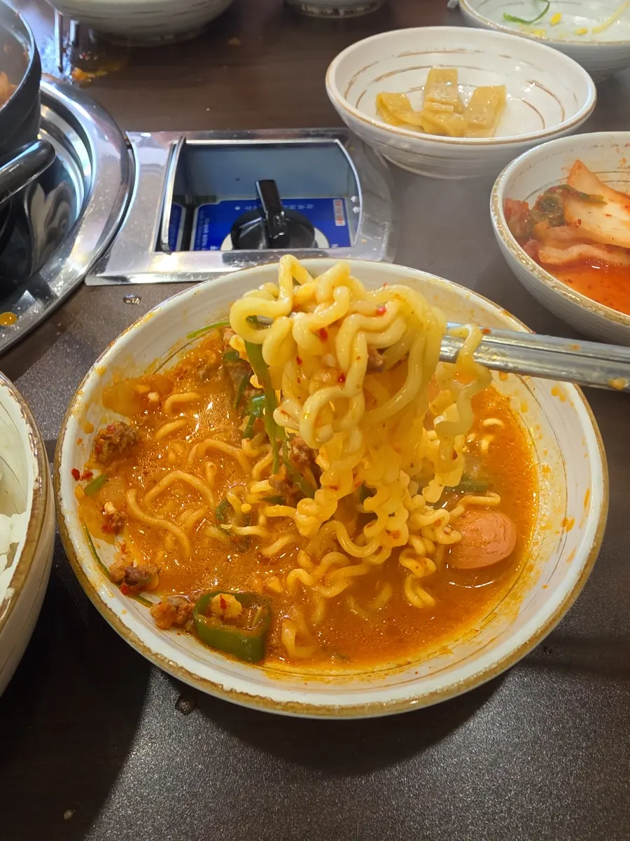 Ramyeon noodles simmered in the budae-jjigae
