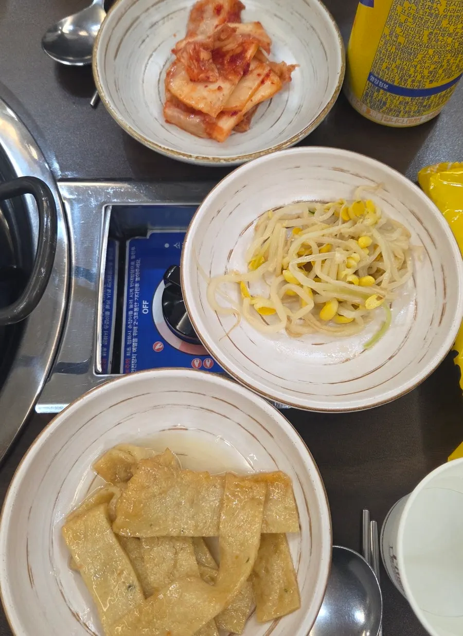 Basic banchan: kimchi, bean sprouts, and stir-fried fish cake