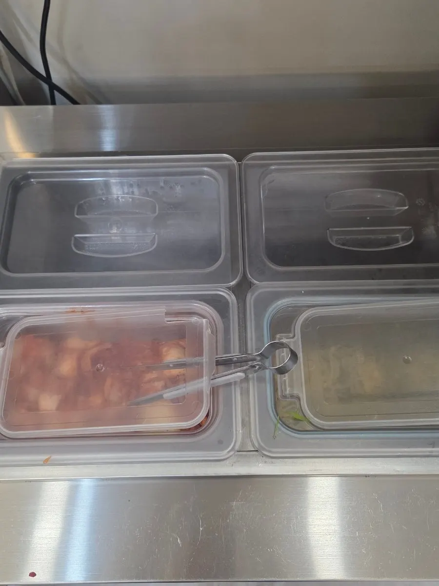 Self-serve banchan corner with kimchi and bean sprouts