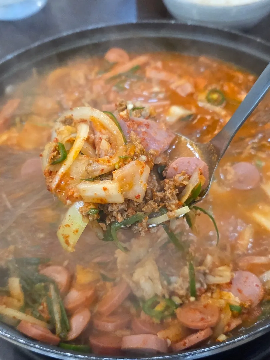 Budae-jjigae topped with beef mince and scallions