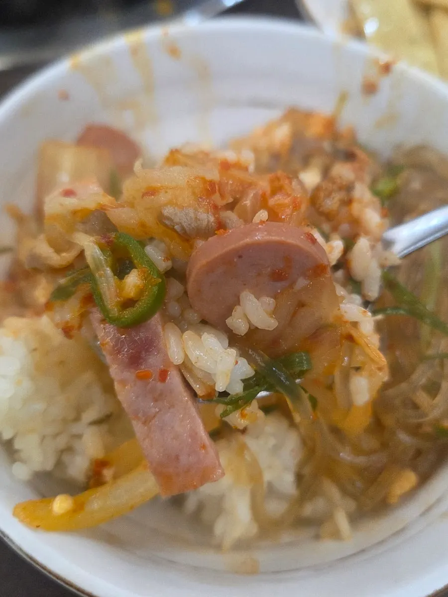 A bowl of budae-jjigae mixed with rice and ramyeon-sarigi